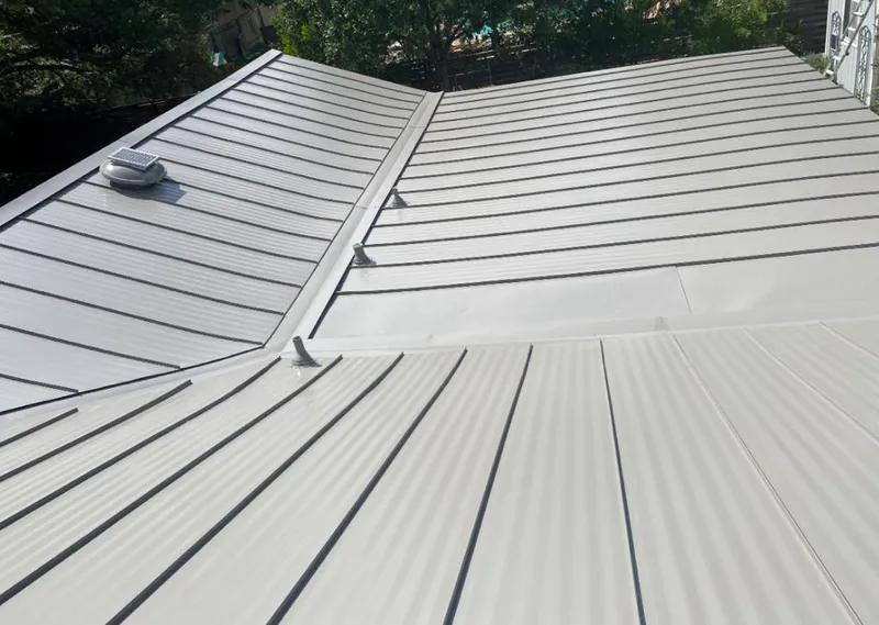 Solar attic fan installed on a metal roof for Roof Ventilation in Johnson City